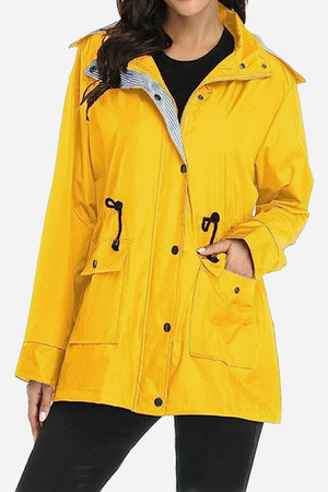 Water resistant yellow hooded striped women's windbreaker jacket with multiple pockets and adjustable waist