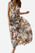 Woman wearing a floral casual sleeveless dress with a flowing skirt and v-neckline