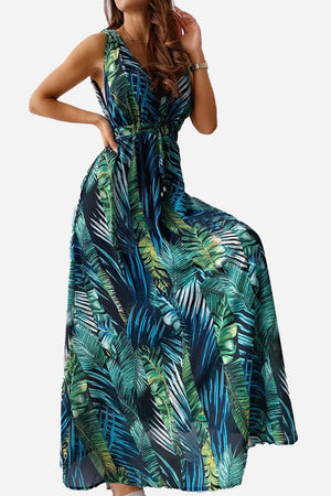 Woman wearing a casual sleeveless dress with green and blue tropical leaf print
