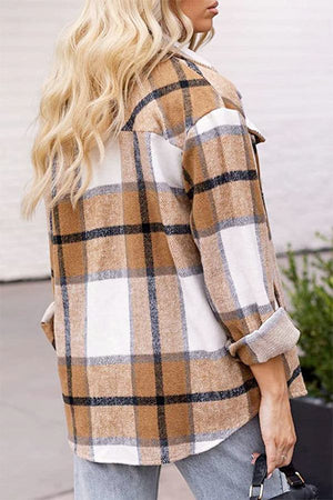 Woman wearing long sleeve plaid flannel shirt in beige, white, and black check pattern, casual fit.