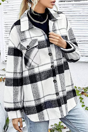 Woman wearing black and white long sleeve plaid flannel shirt with button detail and pockets