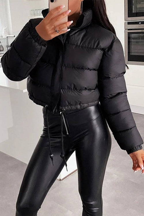 Black sleek cropped puffer jacket paired with black leather pants, stylish winter outerwear