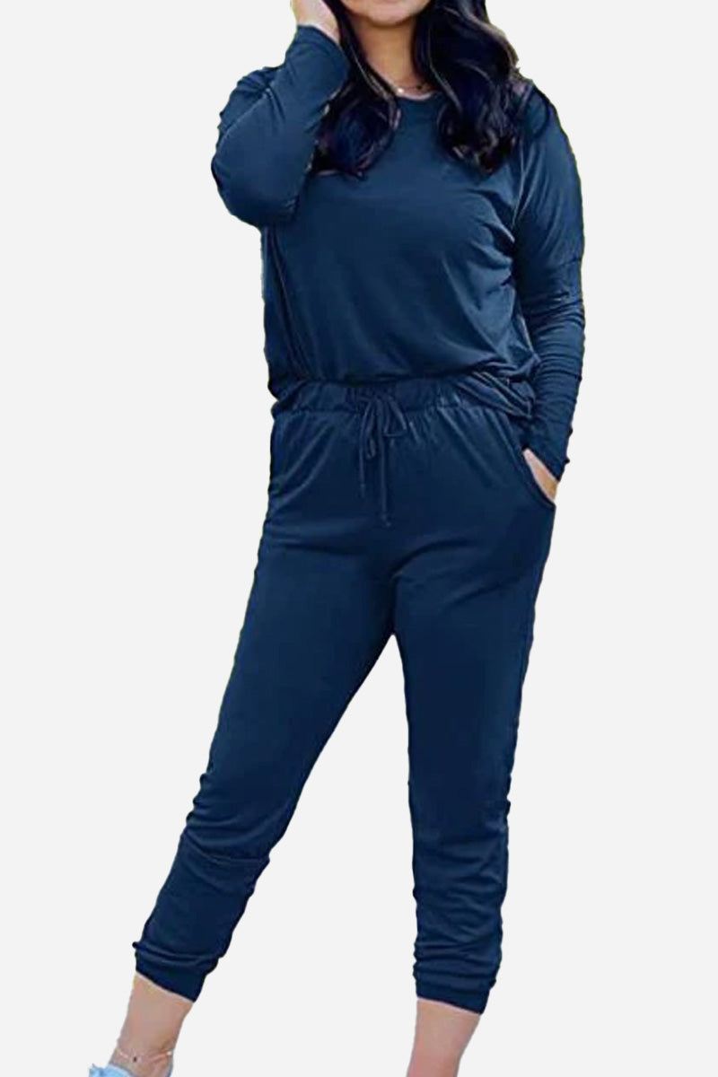 Woman wearing navy blue Cozy Chic Two-Piece Sweatsuit set with long sleeves and high-waisted pants with pockets.