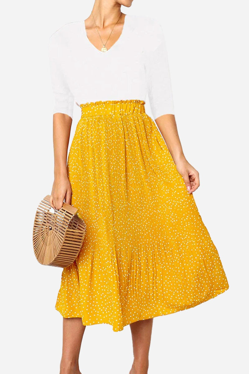Woman wearing yellow high-waist polka dot pleated midi skirt with white top and wooden handbag Effortlessly Chic Polka Dot Pleated Skirt Set