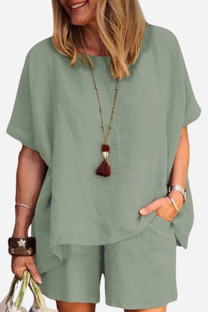 Woman wearing comfy linen-like shirt and shorts two-piece set in light green with casual accessories