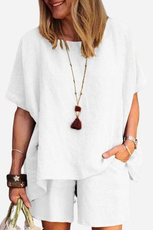 Woman wearing comfy linen-like white shirt and shorts two-piece set with relaxed fit and casual style