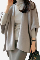 Relaxed flowy open front knitwear cardigan in light grey worn over turtleneck with casual chic style