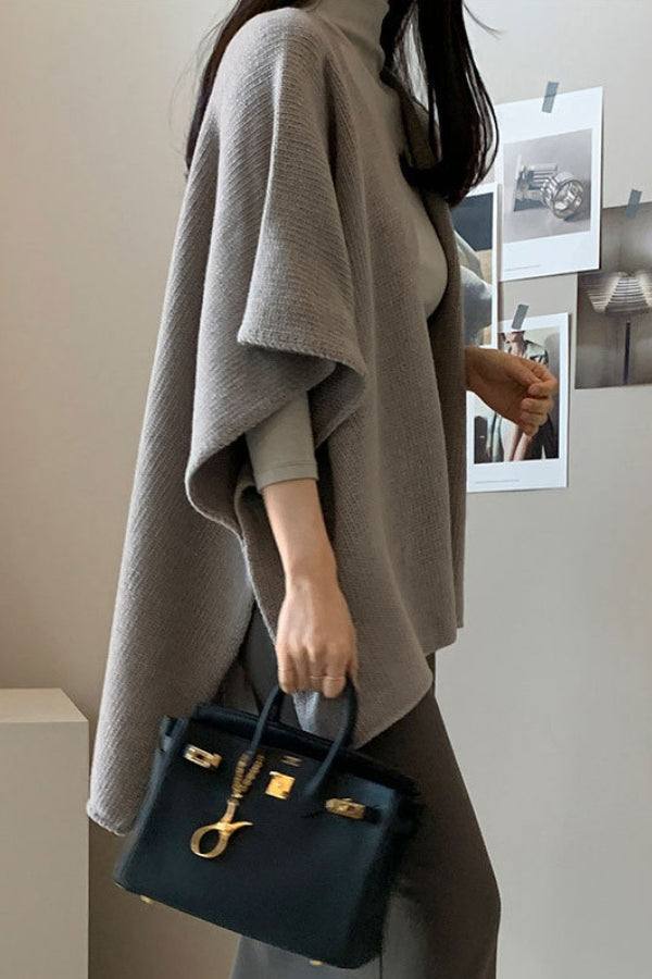 Relaxed flowy open front knitwear cardigan in soft grey, styled with long sleeves and paired with black handbag and casual outfit