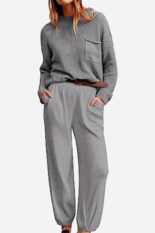 Woman wearing a gray relaxed sweater top and trouser set in European minimalism style