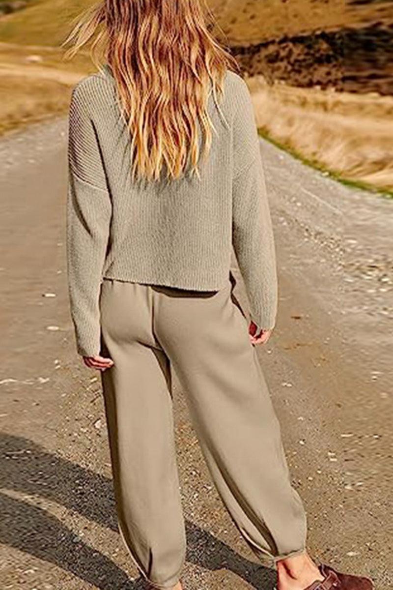 Woman wearing khaki relaxed sweater top and trouser set walking on a rural path showcasing European Minimalism style