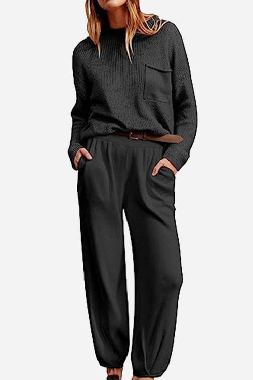 Woman wearing black knit sweater and relaxed trousers set showcasing European Minimalism style