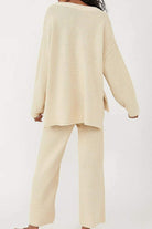 Back view of a woman wearing cream-colored Multi-Weather Comfort two-piece oversized set with long sleeves and wide pants.