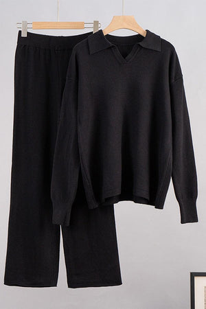black plush and preppy two-piece set with polo collar and wide-leg pants hanging on wooden hangers