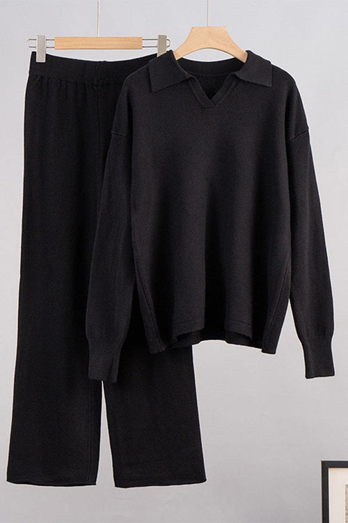 black plush and preppy two-piece set with polo collar and wide-leg pants hanging on wooden hangers