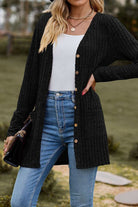 long black lightweight ultra soft knit-like cardigan with buttons and pockets worn with white top and blue jeans outdoors