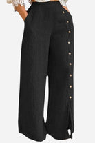 Black wide leg pants with side button detail and high waist, made from breathable cotton blend.
