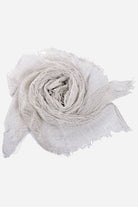 white lightweight linen scarf with frayed edges, soft breathable fabric for versatile style and travel-ready comfort