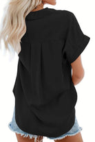 black V-neck collared button blouse with rolled short sleeves worn with denim shorts, back view