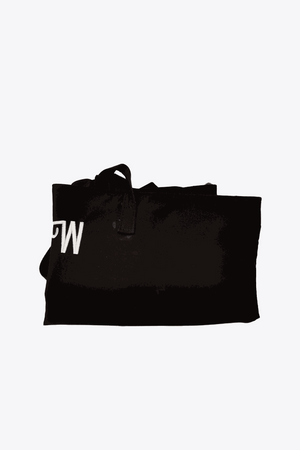 Folded black waterproof travel bag with sturdy handles and minimalist design