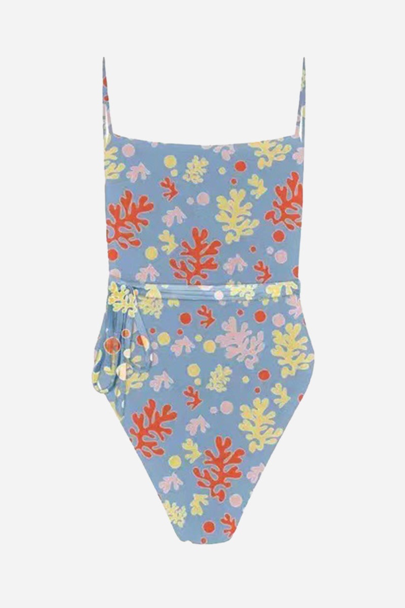 Tan-Through open back one-piece swimsuit with colorful coral print on blue background, featuring adjustable straps and high-cut legs.