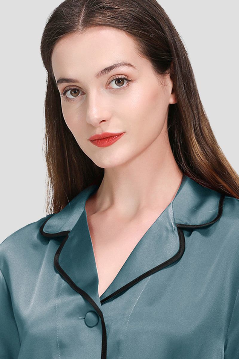 woman wearing teal mulberry silk hemd trimmed pajama top with black hems