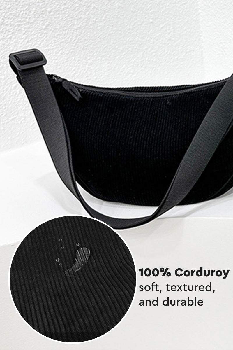 Black corduroy shoulder bag with adjustable strap and zip closure, soft textured lightweight design for everyday use