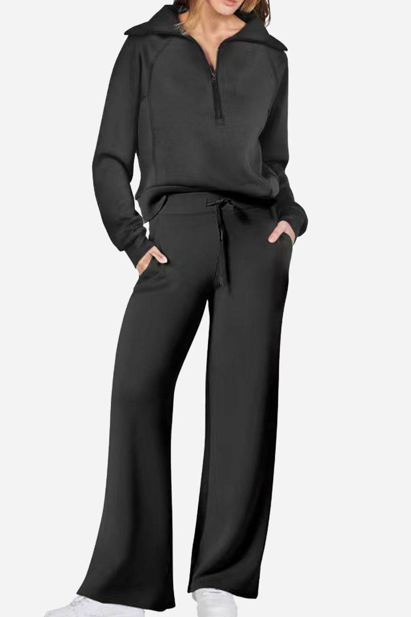 Black loungewear Buttersoft tracksuit set with zip-up top and wide-leg pants, made of ultra-soft polyester for cloud-like comfort.