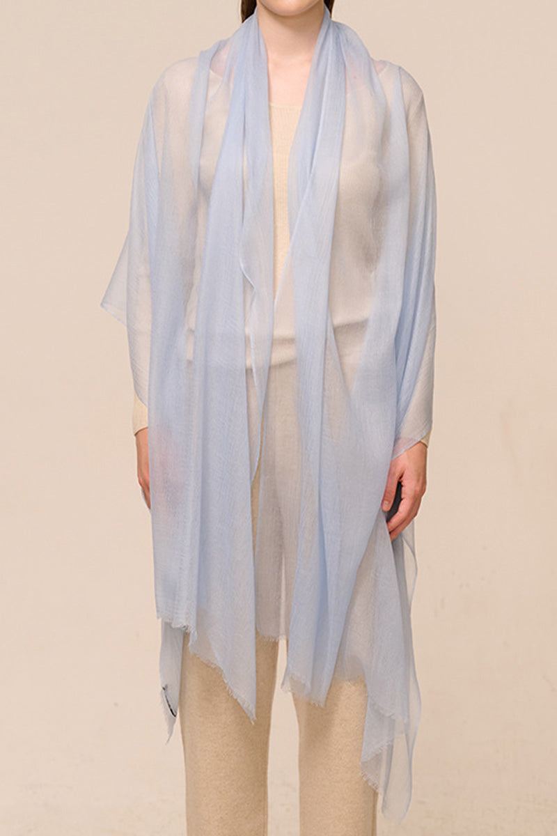 Light blue 100% cashmere featherlight luxury scarf worn over beige outfit