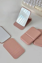 Compact travel pocket mirror with durable PU leather case in pink, lightweight and portable for on-the-go touch-ups.