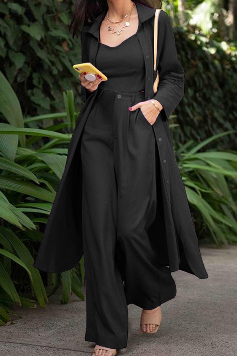 Woman wearing black relaxed fit shirt and trouser three-piece set with long shirt and wide-leg trousers outdoors