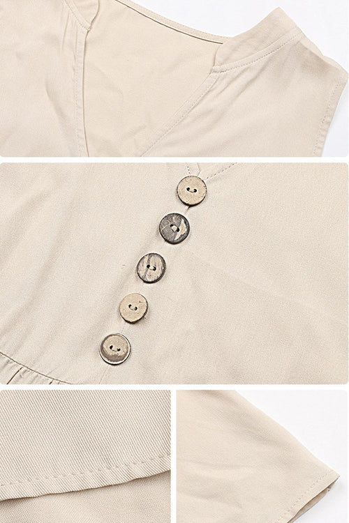 Close-up of beige Bohemian tiered midi dress with V-neck and button detail on lightweight viscose fabric.