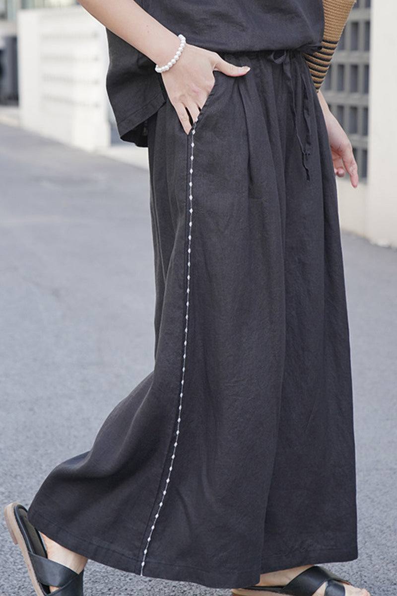 Black 100% linen wide-leg pants with elastic waist and side seam detail