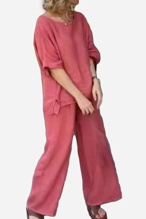 Woman wearing a soft pink 100% cotton two-piece set with wide-leg pants and a relaxed short-sleeve top.