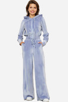 Light blue velour tracksuit with cropped hoodie and high-waist pants on model