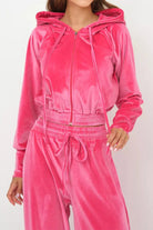 Pink velour tracksuit with cropped hoodie and high-waist drawstring pants in plush, smooth fabric