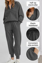 Unisex half-zip pullover and sweatpants set in dark gray with stand collar, elastic waistband, and side pockets for casual comfort
