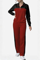 Woman wearing Colorblock Comfort Leisure Set with red and black color-block design, half-zip stand collar top, and wide-leg pants.