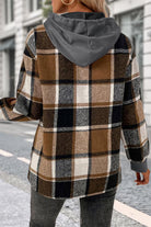 Back view of woman wearing Countryside Layered Hoodie with brown plaid design and gray hood outdoors