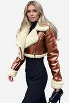 Cropped faux leather sherpa jacket with cream fleece lining and trim, warm and stylish outerwear.