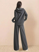 Woman wearing charcoal gray lyocell-blend hooded set with wide-leg pants, back view