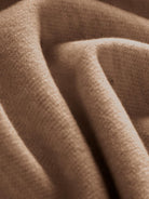 Close-up image of soft beige thermal wool blend trousers fabric texture