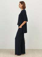 Woman wearing oversized long-line pullover and wide-leg pants loungewear set