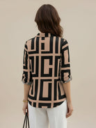 Floral button-down shirt with long roll-up sleeves and relaxed fit for casual or workwear