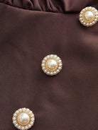 Woman wearing slimming V-neck midi dress with button-front and ruffle cuffs