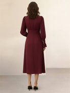 Woman wearing slimming V-neck midi dress with button front and ruffle cuffs