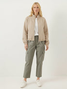 Cropped textured baseball jacket with full zipper and elastic cuffs on white background