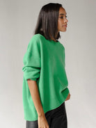 Oversized crew neck knit sweater with drop-shoulder sleeves and ribbed cuffs in neutral color