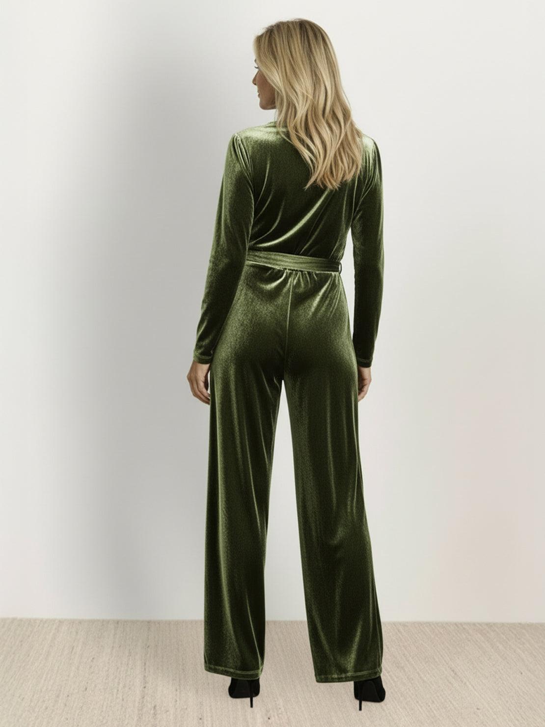 Woman wearing a deep V-neck velvet suit with long sleeves, removable waist tie, and wide-leg pants