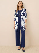 Woman wearing open-front three-piece co-ord with longline cardigan, tank top, and wide-leg trousers in lightweight knit fabric