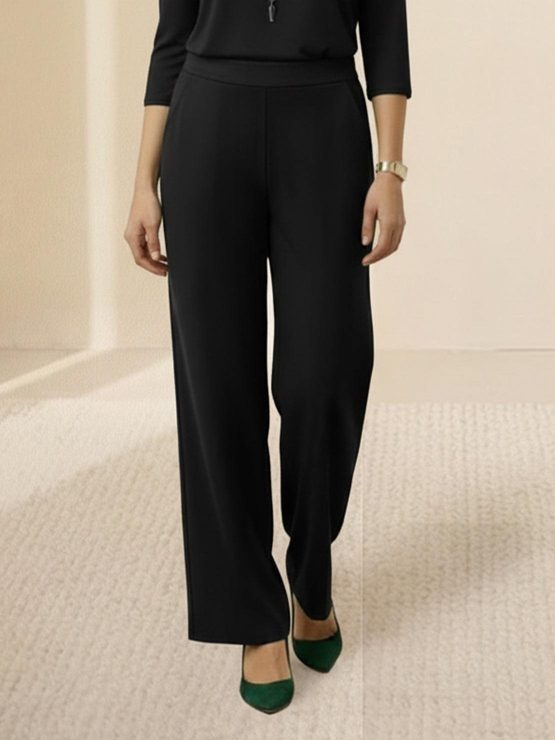 Woman wearing open-front three-piece co-ord with longline cardigan, tank top, and wide-leg trousers